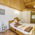 Wellness Resort Romantika in Hauzenberg: wooden bedroom with twin beds and vaulted ceiling