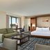 Hilton Orlando Lake Buena Vista - Disney Springs Area guest room with bed, sofa, desk and balcony view