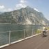 Park Hotel Abbadia in Abbadia Lariana: cyclists on a lakeside path beside mountains and water