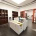 Guoyi Hotel Beijing lobby with display shelves and central table on dark wood flooring