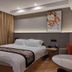 Yangjianhua Hotel in Shanghai guest room with king bed, desk, and seating area