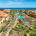 Pestana Porto Santo in Porto Santo with palm-lined pools, ocean views, and red-roofed resort buildings