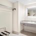 Days Inn by Wyndham Fontana / Rialto bathroom vanity with mirror, sink, towel bar and closet