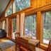 Copper Creek Inn, Cabins and Lodge in Ashford: cabin living room with tall windows and forest views