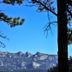 The Historic Crags Lodge, Estes Park: mountain view framed by pine trees under a clear blue sky