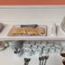 Hosteria Ailen in Ushuaia breakfast buffet with sliced bread, pastries, cups, and plates