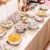 Breakfast buffet at Hotel Taormina in Bardolino with bread, yogurt cups, fruit, and bowls of cereal