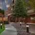 Courtyard by Marriott Fayetteville exterior with gazebo, landscaped walkway, and brick hotel entrance