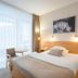 Hotel Behounek in Jáchymov guest room with bed, balcony doors and seating area