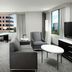 Hilton Woodland Hills/Los Angeles guest room with city views, sofa, chairs, desk and TV