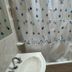 Hosteria Ailen in Ushuaia bathroom with shower curtain and sink