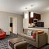 TownePlace Suites by Marriott Williamsport living room with sofa, armchair, ottoman and kitchenette