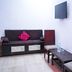 Hotel Ashoka Palace Near Igi Airport, New Delhi room with sofa, wall TV, and table seating