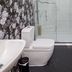 G Boutique Hotel Portsmouth bathroom with walk-in shower, toilet, sink and marble-look wall tiles