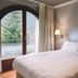 Abba Xalet Suites Hotel in Sispony guest room with arched balcony door and mountain view