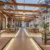 Hotel Himalaya Kathmandu in Kathmandu: bright indoor corridor with wooden beams, seating, and potted plants