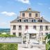 Domaine De La Corniche in Rolleboise, exterior of the hotel with stone facade and garden entrance