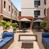 TownePlace Suites by Marriott Williamsport courtyard with blue lounge seating and umbrella tables