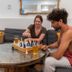 Auberge Saintlo Montréal Hostel in Montreal lounge with guests playing chess by a round table