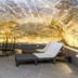 Järvsöbaden in Järvsö features a stone grotto spa with a small pool and lounge chair