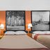 Super 8 by Wyndham Port Royal/Beaufort room with three beds and black-and-white wall art