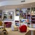 Hotel Borgo Brianteo in Ponte San Pietro lounge with bookshelves, colorful chairs and wall art