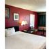 OYO Hotel Georgia Near Fairburn/Atlanta room with bed, lamp, desk and maroon walls in Union City