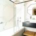 Royal Plaza Hotel Tiberias bathroom with walk-in shower, vanity sink, large mirror, and towel bench