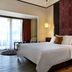 Novotel Lombok Resort & Villas in Kuta, guest room with king bed, wood floors and balcony doors