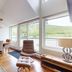 Hébergement Mont-Ste-Anne Condos in Beaupre living room with dining area, large windows and mountain view