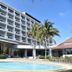 BP Samila Beach Hotel and Resort in Songkhla with a pool, palm trees, and oceanfront resort building