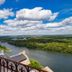 Domaine De La Corniche in Rolleboise overlooking a river, bridge and green landscape under cloudy skies