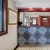 Econo Lodge Charlotte Airport Area lobby front desk in Charlotte with patterned tile and red accent wall