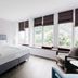 Parkhotel Fritz Am Brunnen in Schwelm guest room with large windows and a bed beside a chair