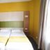 Hôtel de France Boulogne-Billancourt room with twin beds, yellow walls and desk