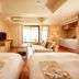 Moon Ocean Ginowan Hotel & Residence room with twin beds, sofa, kitchenette and balcony view in Ginowan