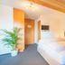 Hotel Sonne - Self Check-in in Schwarzenburg guest room with double bed, potted plant and wall-mounted TV