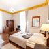 Malopolanka & Spa in Krynica-Zdrój guest room with bed, striped sofa, wardrobe and chandelier