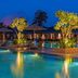 Ibis Styles Sepang Klia poolside with lit palm trees, lounge chairs and evening resort ambiance in Sepang