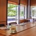 Resort Bad Boekelo meeting room with large windows overlooking a patio and umbrellas in Boekelo