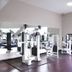Residence & Conference Centre - Oakville fitness room with gym equipment and large window