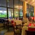 The Kairaba Beach Hotel in Serrekunda dining room with set tables and large windows overlooking greenery