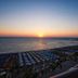 Sunset sea view from Mediterranean Hotel in Rhodes overlooking beach umbrellas and coastline