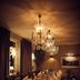 Åsby Hotell in Hallstahammar dining room with a long set table and chandelier lighting