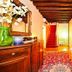 Art Palace - Residenza Giardini Venice interior with red staircase, patterned rug, and hallway seating