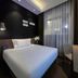 Orange Hotel Beijing Tianning Temple room with bed, desk, chair and floor-to-ceiling window in Beijing