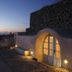 Aghios Artemios Traditional Houses in Thera, sunset view of stone terrace and arched doorway