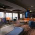 Courtyard by Marriott Fayetteville lobby lounge with seating, bar area and large windows in Fayetteville
