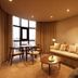 Montebelo Viseu Congress Hotel in Viseu living room with sofa, dining table and large window