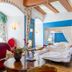 Hotel Burg Trendelburg in Trendelburg: colorful room with canopy bed, blue walls, exposed beams and sitting area